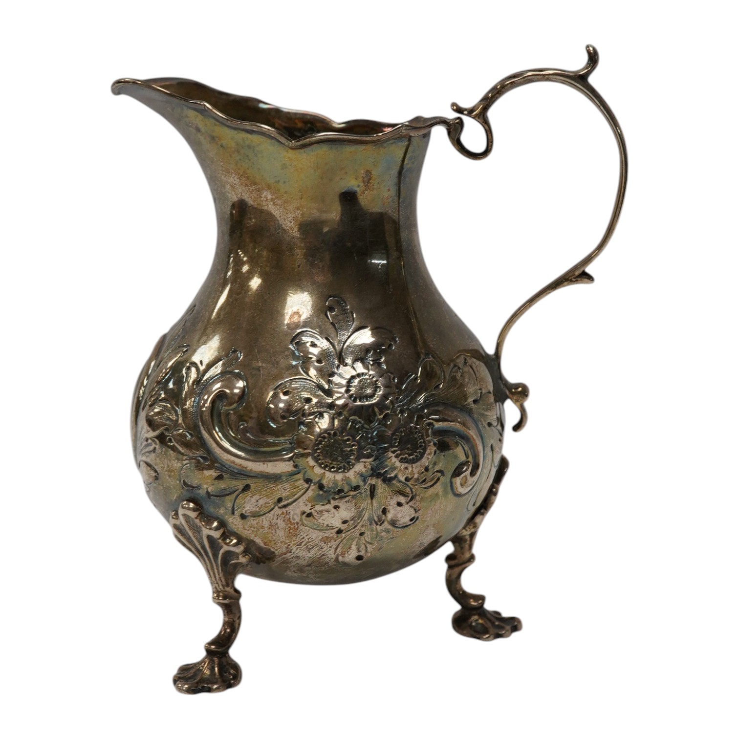 A George III silver cream jug, with later embossed decoration, London, 1766, 12.7cm, 5.7oz. Condition - poor